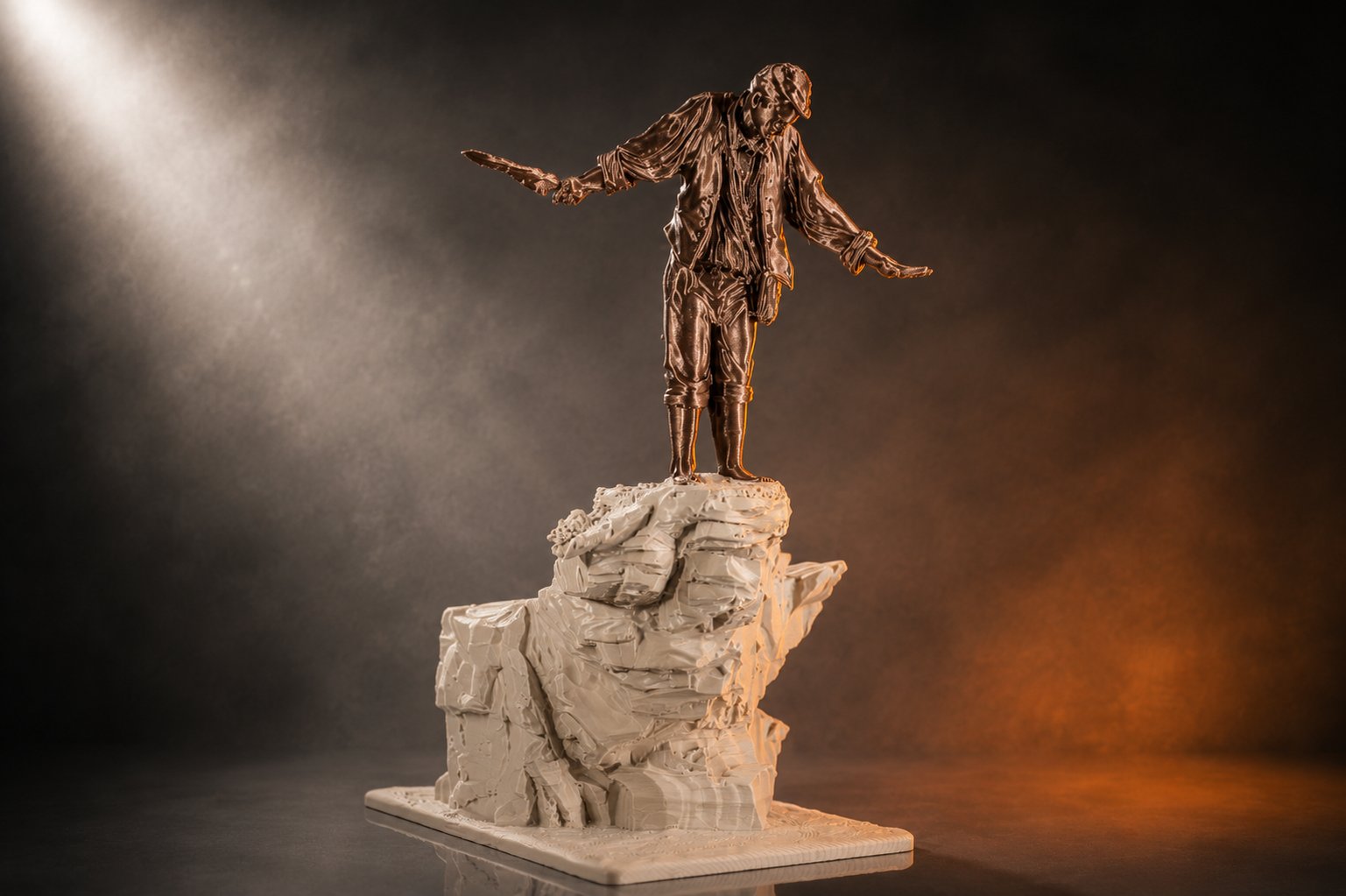 A 3D printed figure on a rocky base lit by a warm spotlight.