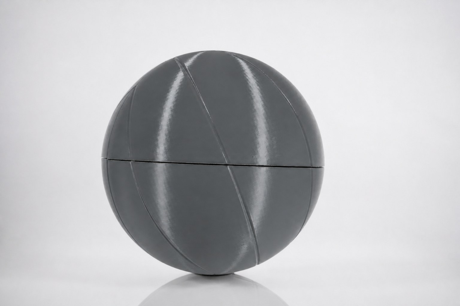 The finished 13-inch printed basketball, four assembled shell quarters.
