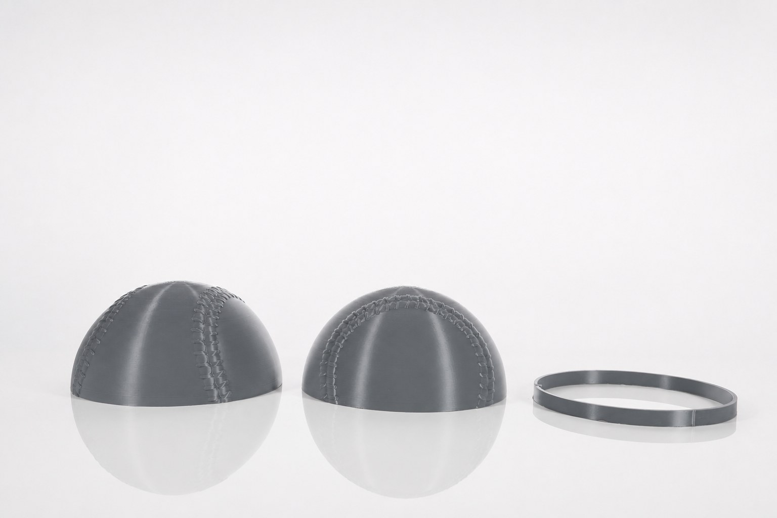 The 9-inch baseball as two printed hemispheres with alignment ring.