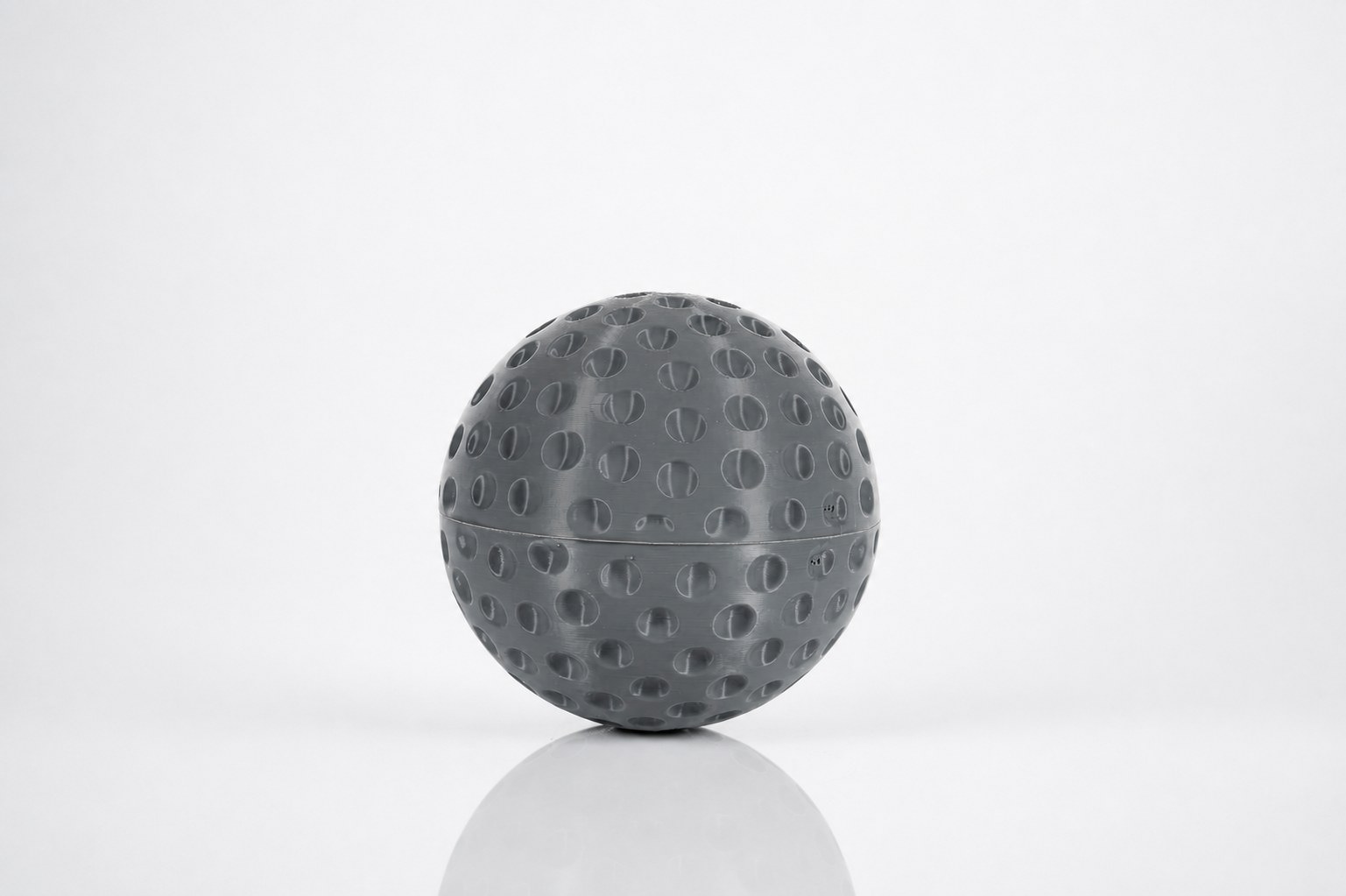 The finished 7-inch printed field-hockey ball with dimpled surface.