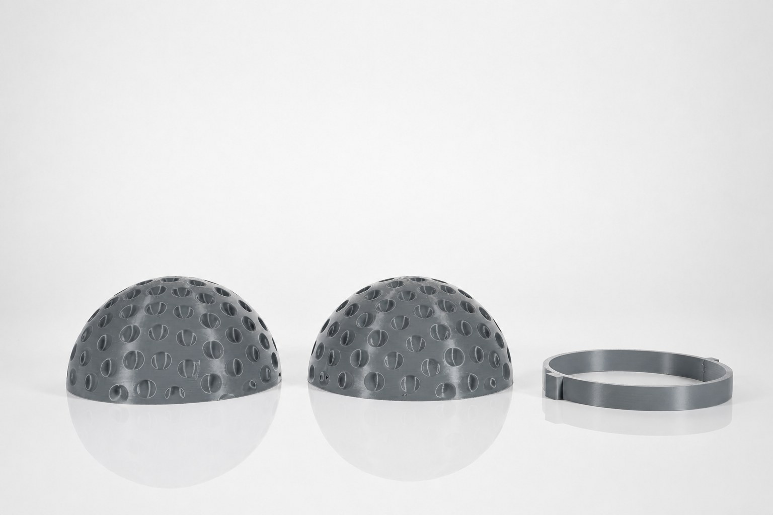 The field-hockey ball as two dimpled shells with alignment ring.