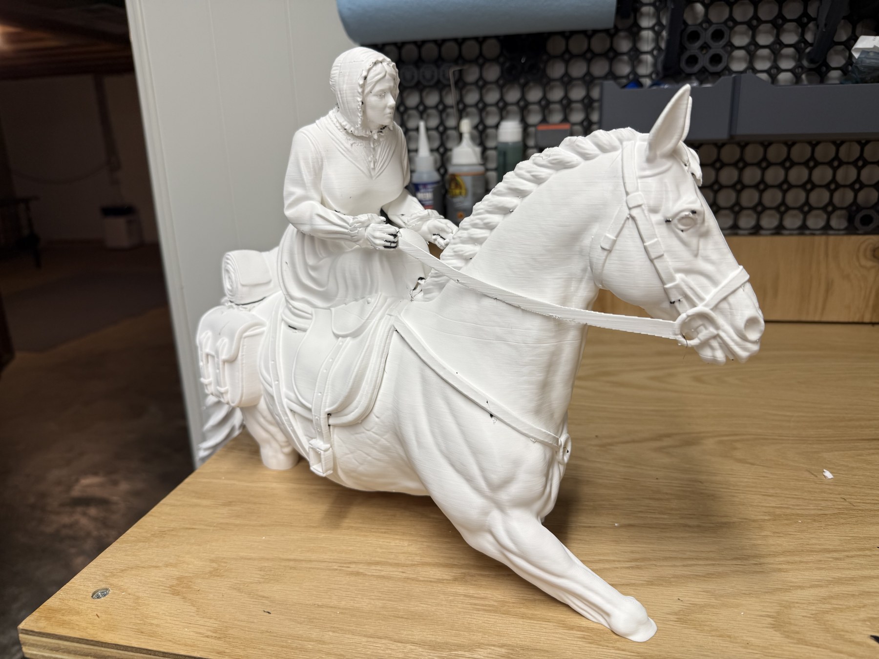Front three-quarter view of the printed horse and sidesaddle rider.