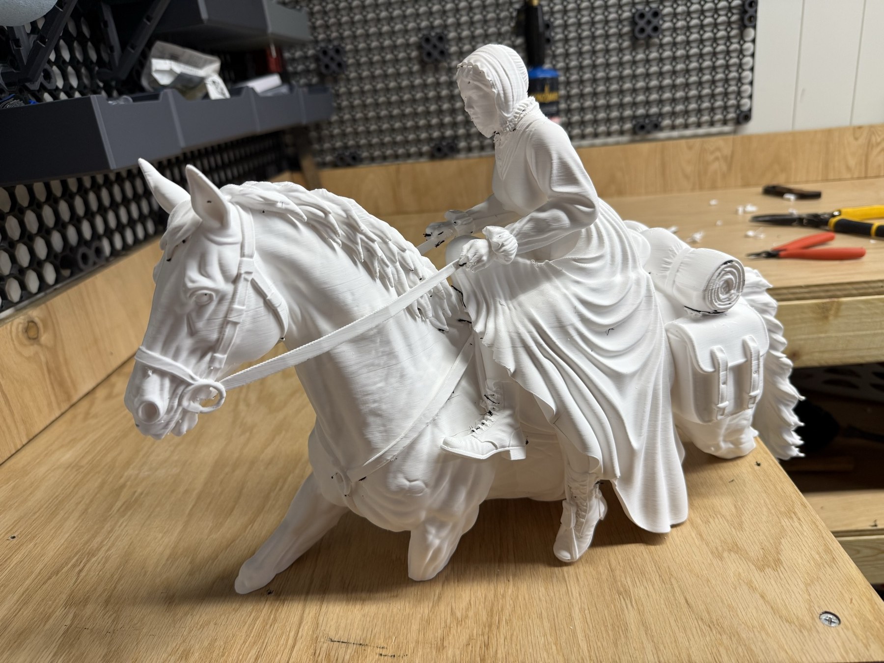 The printed horse and sidesaddle rider on the workbench, showing the head, bridle, reins, dress, bedroll and saddlebag.